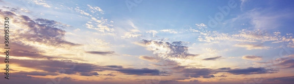 Fototapeta Sky at sunset with dark clouds, panoramic big shot. Background from the cloudy sky