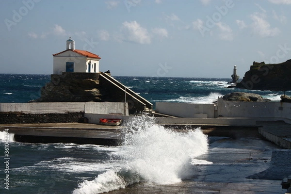 Fototapeta Waves at the small harbour in front of the Chapel of Panagia Thalassini at Andros, Greece 
