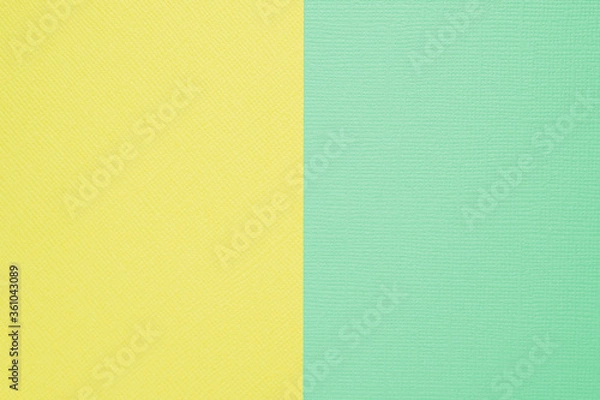 Fototapeta Two-color paper background. The background is yellow and delicate mint color, divided vertically equally.