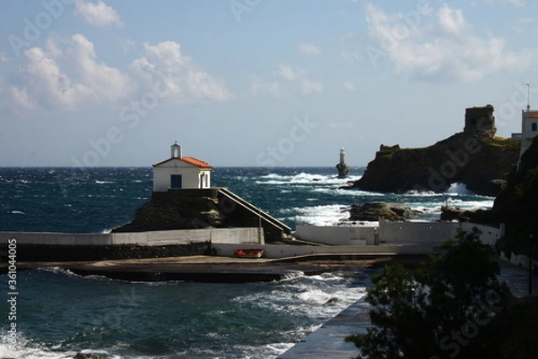Fototapeta Waves at the small harbour in front of the Chapel of Panagia Thalassini at Andros, Greece 