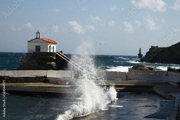 Fototapeta Waves at the small harbour in front of the Chapel of Panagia Thalassini at Andros, Greece 