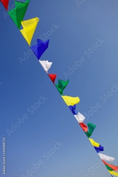 Fototapeta Bright colorful buddhist Prayer flags on clear blue sky background. Multi colored Prayer flags in Himalaya mountains. Buddhist symbols. Freedom. Meditation. Zen-like backgrounds. Flags in the sky.