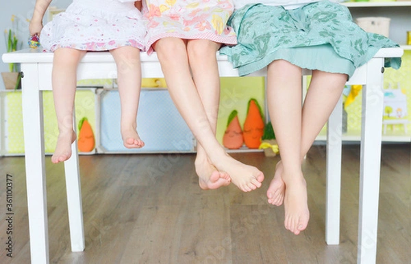 Fototapeta three sisters sitting on the table