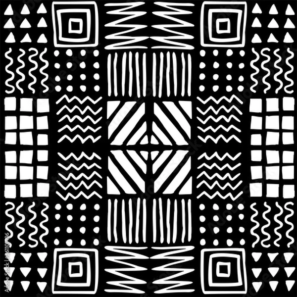 Fototapeta Vector seamless geometric pattern of hand-drawnsquares, stripes, lines, dots, zigzags. Ethnic white pattern on a black background. For decor, textile, fabric, wrapping, carpet, wallpaper, background.