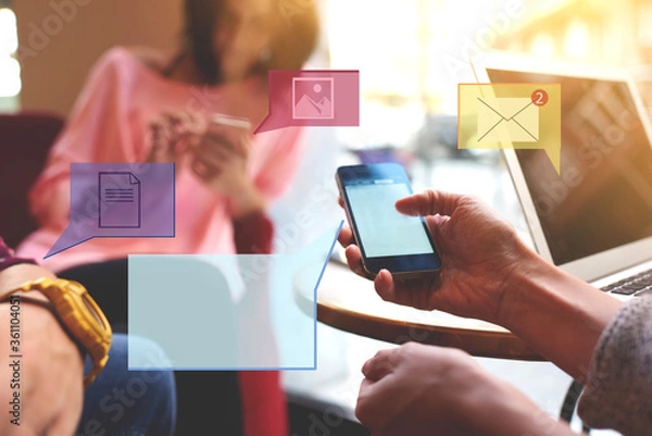 Fototapeta Close up of group of friends holding mobile phone and sharing online multimedia files. Millennial smartphone users communicating via applications. Infographics message icons, chatting symbol