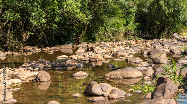 Obraz Small stream of fresh water and rolled stones in the interior of Brazil