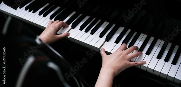 Obraz Beautiful woman playing piano, learn to play piano.