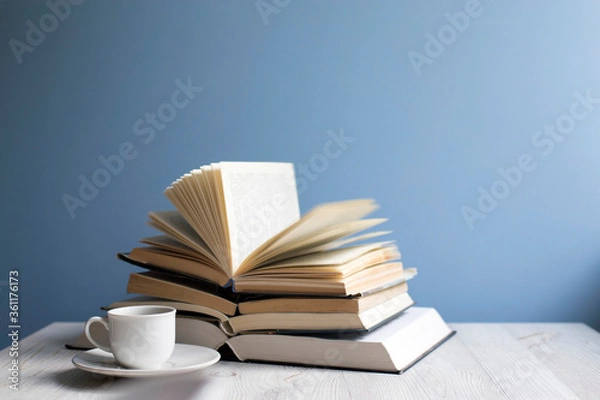 Fototapeta open book and cup of coffee on a background of a blue wall. Concept - online learning.