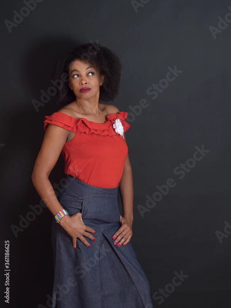 Obraz Sensual African American woman wearing a red summer top with a wondering look