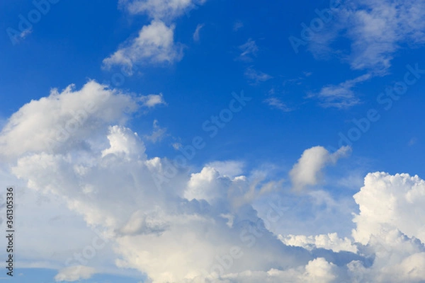 Obraz White clouds against the blue sky background in sunny cloudy summer day.
