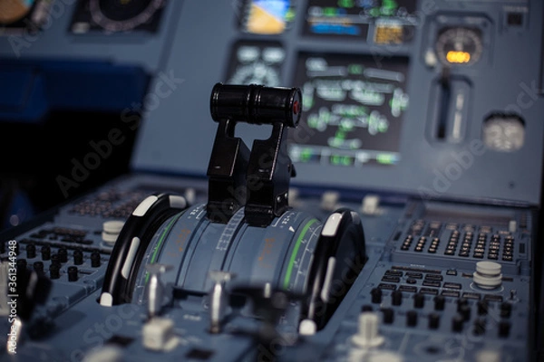 Fototapeta Control aviation panel of plane in cockpit. Plane cockpit with many function to control. Engine control wheel. Aviation dashboard in bussiness aviation.