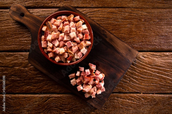 Fototapeta closeup of cubes of bacon on a rustic wooden board. Raw