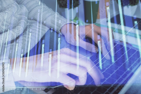 Fototapeta Double exposure of woman hands typing on computer and forex chart hologram drawing. Stock market invest concept.