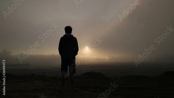 Fototapeta man walking in the fog