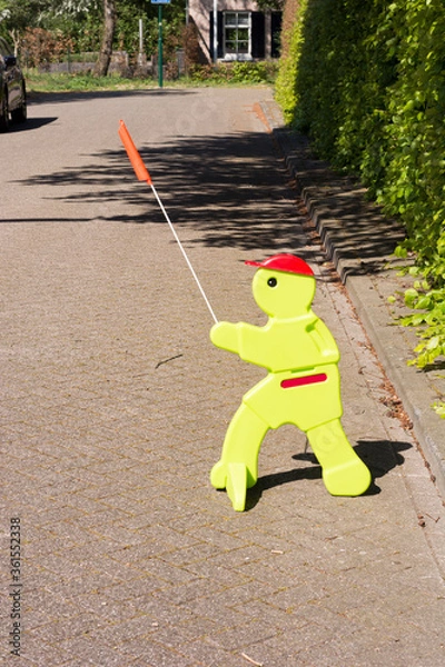Obraz View on plastic figure on the street, standing there to warn cardrivers to drive slowly. Children might be playing and overlook cars. This sign is meant to improve caution and carefulness