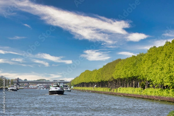 Obraz View on the Amsterdam Rijn Kanaal in the Netherlands, an important waterway for shipping freight on large boats and ships. Also an environment with possibilities for recreation.