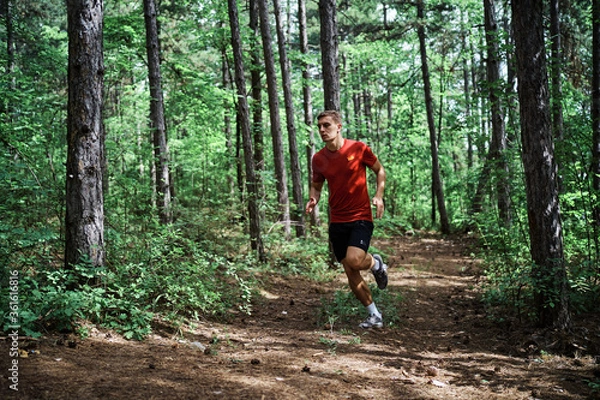 Obraz Young man running alone on an empty road