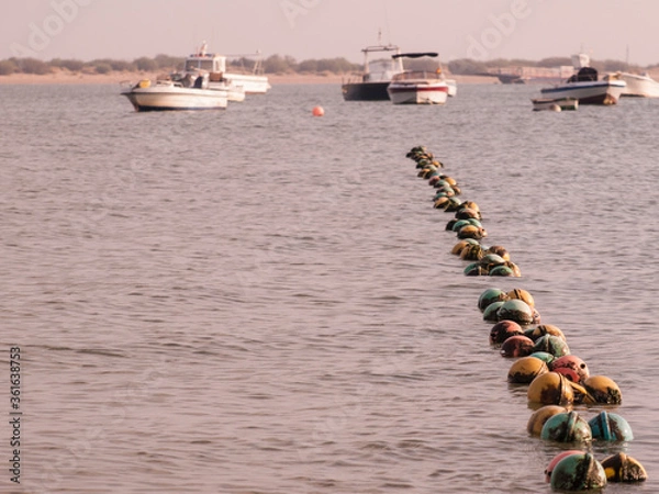 Obraz small boats moored in the river near the mouth