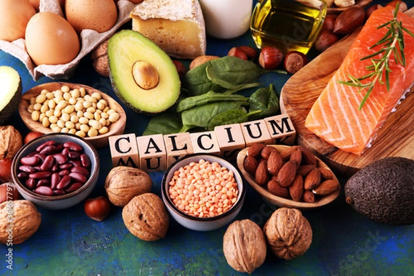 Fototapeta Best Calcium Rich Foods Sources. Healthy eating. Foods rich in calcium such as bean, almonds, hazelnuts, spinach leaves, cheese, and fresh milk