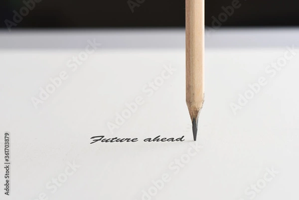 Fototapeta Future ahead word with pencil on white paper on black background, business challenge concept and leadership success idea