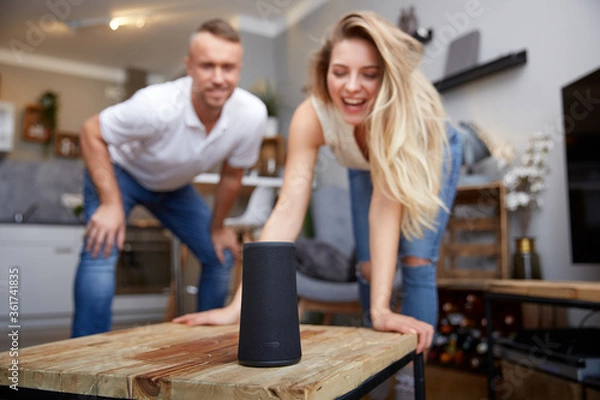 Obraz Smiling Woman With Boyfriend Looking At Smart Speaker