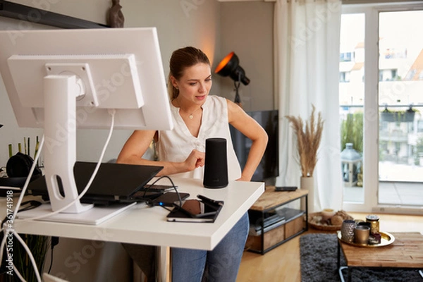 Obraz Beautiful Young Woman Talking To Smart Speaker