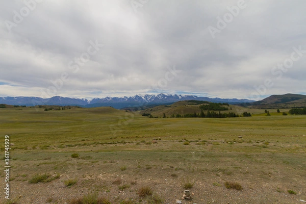 Fototapeta Panoramic view of a mountain valley summer, white clouds. Altai mountains. Dark day.