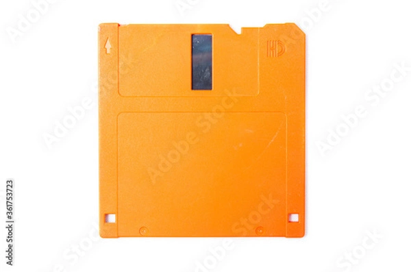 Obraz Floppy orange 3.5 on a white background. Floppy disk general plan and close-up. Floppy disk in a male hand on a white background