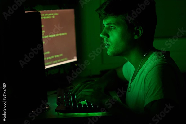 Fototapeta teenager hacking something from a computer