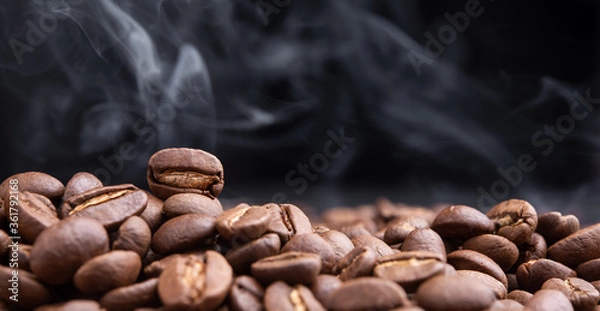 Obraz Aroma roasted coffee beans with smoke rising over dark background