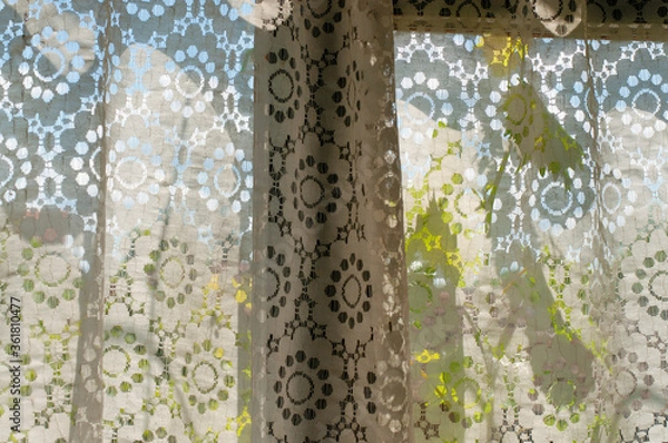 Fototapeta Old retro laced curtain on a wooden window on a rural house 