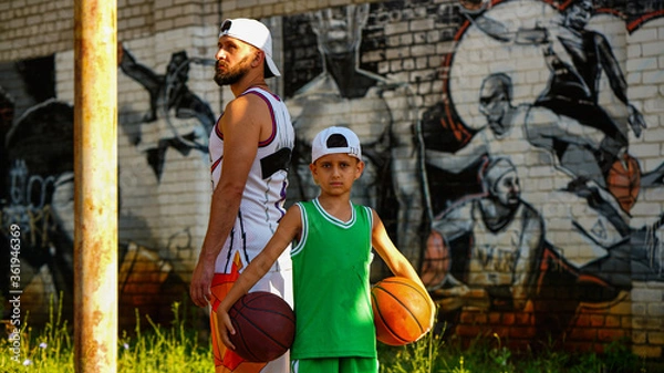 Obraz Basketball family father with beard and son in jersey with balls