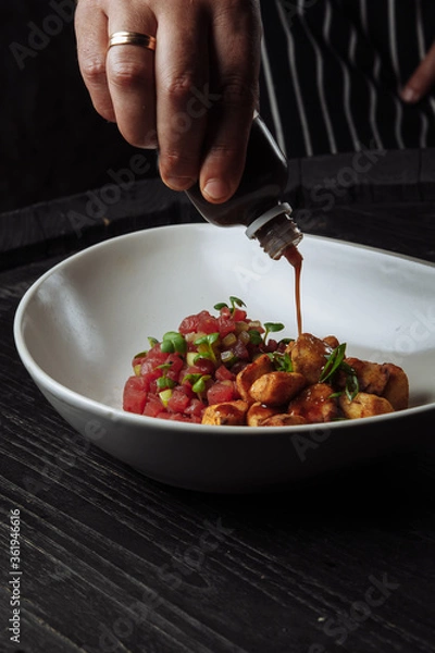 Obraz chef cooks turkey salad with sesame sauce and