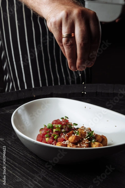 Obraz chef cooks turkey salad with sesame sauce and