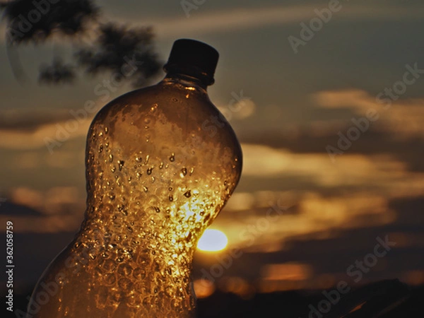Obraz Plastic bottle pierced by the sun's rays