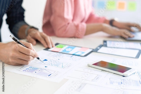 Fototapeta Creative team analyzing prototype products for product design in Co-working Space
