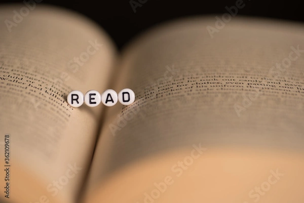 Fototapeta The word read on a book,selective focus with dark background