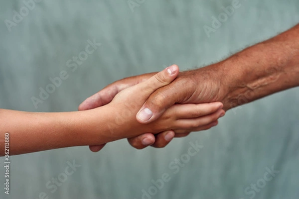 Obraz Hands of the son and father close-up . Family concept of care and love