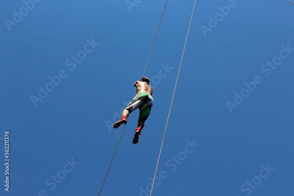 Obraz man climbing on a rope