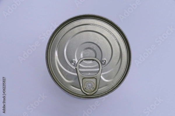 Fototapeta Can of food viewed from above with gray background.
