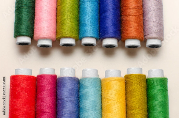 Fototapeta Multicolor sewing thread roll background