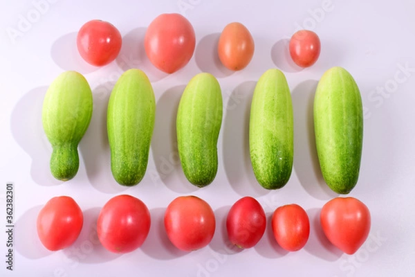 Fototapeta Cucumbers and tomatoes isolated from a white background