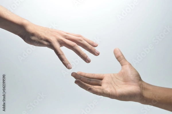 Fototapeta Two male hands reaching towards each other on isolated white background