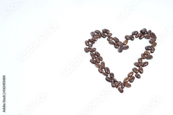 Fototapeta Roasted coffee beans in shape of hart on white background