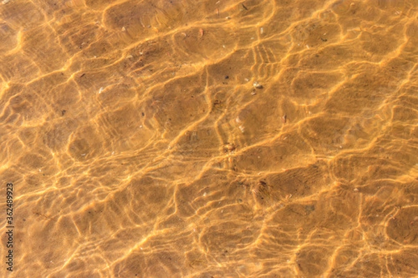 Fototapeta Texture of ripple sea water with sand bottom for background