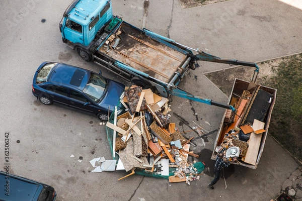 Fototapeta Accident: Garbage container fell over blue car