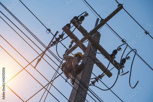 Fototapeta The power lineman uses insutated tool to open the connection of the transformer from the high voltage distribution system. To change the drop out fuse cut out that protects the transformer.