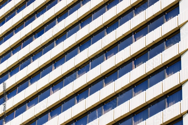 Obraz Repeating pattern of a large number of Windows.Facade of a modern hotel building.Geometric pattern.Urban architecture.Daylight illumination.The view from the bottom up.