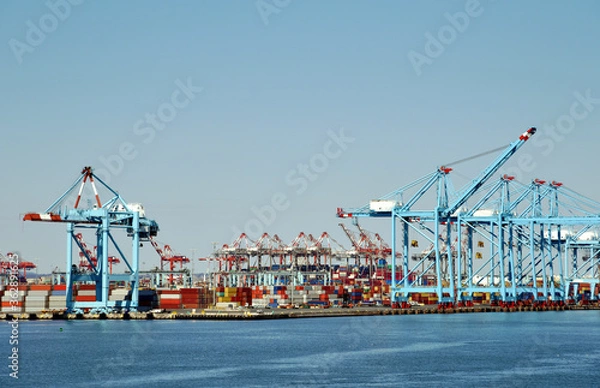 Fototapeta Newark, NJ / USA - View of the container terminal with gantry cranes and stored containers.  