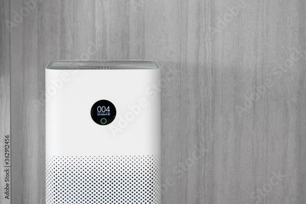 Fototapeta Indoor air purifier with digital monitor screen in living room, show air quality in the room and air pollution levels in the room. with wood laminate wall background